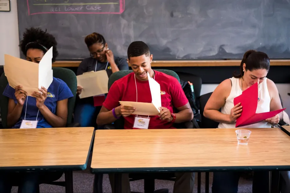 Students looking at documents at desks